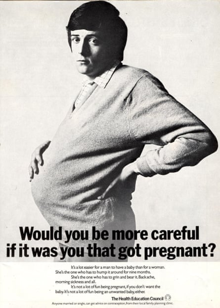 A man looking very sorry for himself has one hand on his back and another cradling his pregnant belly