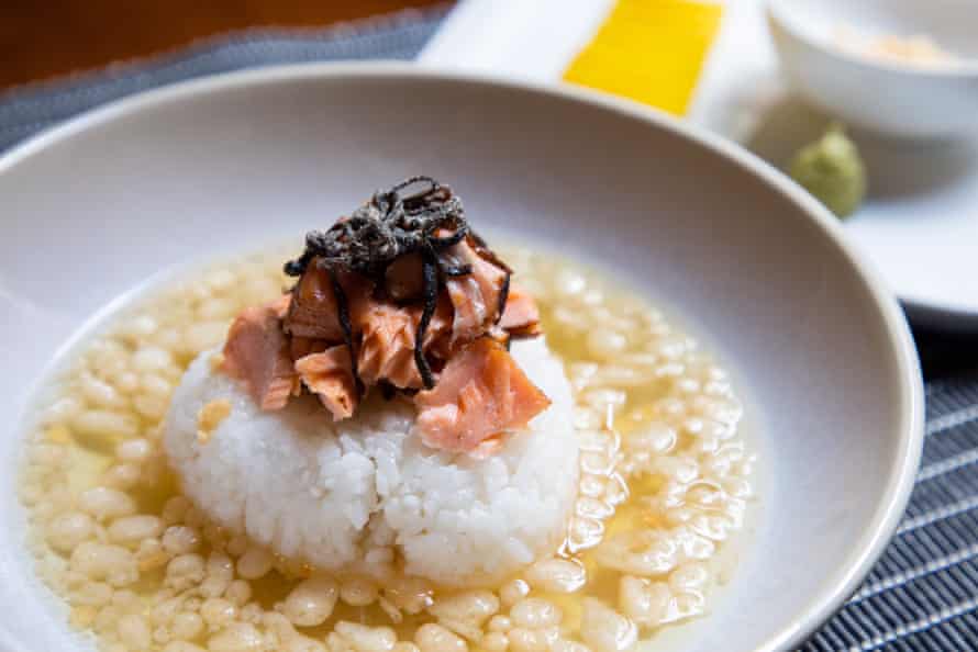 Flakes of grilled salmon and shio kombu (seasoned seaweed) rest on a ball of rice