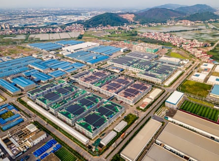 An industrial park with factories with solar panels on top of their roofs