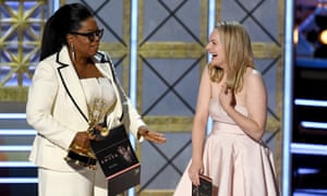Actor Elisabeth Moss accepts Outstanding Drama Series for The Handmaid’s Tale from Oprah Winfrey onstage during the 69th Emmy Awards.