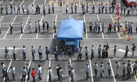 People wait to take coronavirus tests in Ulsan, South Korea.