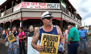 Pro-Adani supporters gather outside the Commercial hotel in Clermont, central Queensland, to protest against the arrival of anti-Adani environmental activists on Saturday.