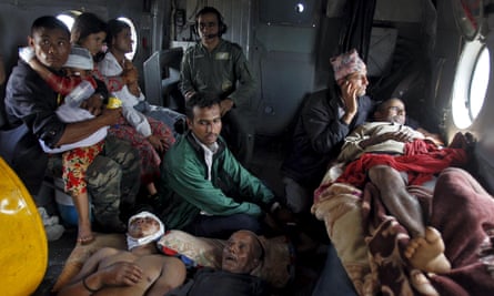 Victims of the earthquake rest inside an Indian Air Force helicopter as they are evacuated from Trishuli Bazar to the airport in Kathmandu.