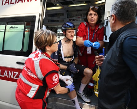 Thomas Gloag receives medical attention after being involved in a crash with a police rider