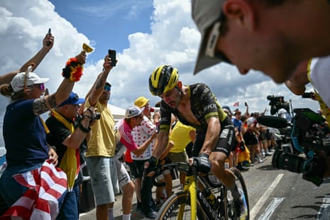 Victor Campenaerts cycles uphill through a crowd