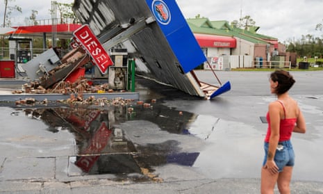 Hope Laird looks at the wreckage of a gas station near her home after the arrival of Hurricane Idalia in Perry, Florida, 30 August 30, 2023.