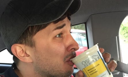 A close-up of Martyn in a cap, sipping custard