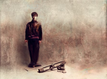 A man standing next to a pile of wood.