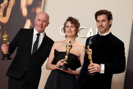 Oscar glory … with Emilia Pérez director Jacques Audiard, left, and husband Clément Ducol.