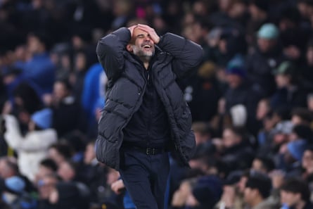 Pep Guardiola holds his head in his hands