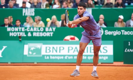 Carlos Alcaraz plays a backhand during his 3-6, 6-0, 6-1 win over Francisco Cerundolo