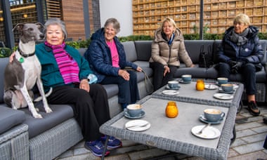 Residents, who include Pi the dog, meet for coffee at Audley’s retirement village in Clapham.