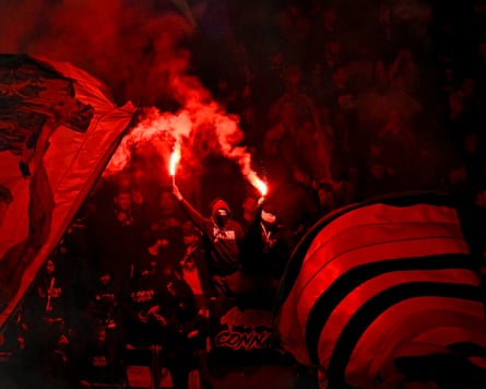 PSG fans light flares after their team took the lead against Barcelona.