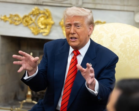 Donald Trump gestures while speaking in the Oval Office