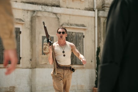 A white soldier in sunglasses holds a gun and shouts