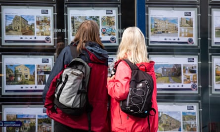 People look at properties in an estate agent's window in Holmfirth, Britain, on September 29, 2022.