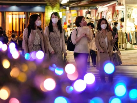 Pedestrians look at seasonal illuminations in Tokyo as crowds return to the capital.