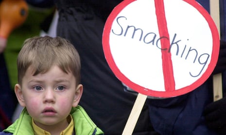 A child holds an anti-smacking sign