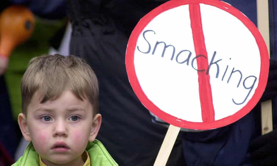A child holds an anti-smacking placard.