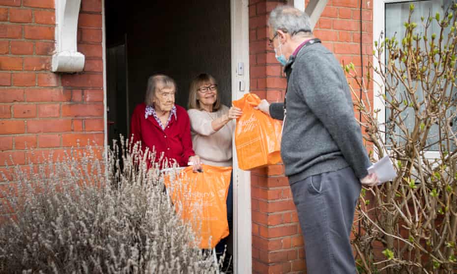 Rob Costa, 62, delivering audio books to Mabel, 104 and her daughter Chris, 67 in north London