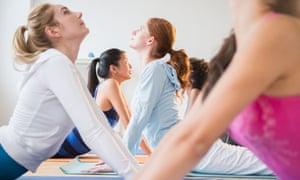 Women practising yoga in class