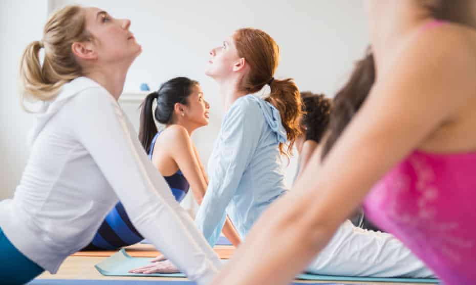 Women practising yoga in class