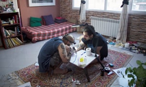 Soheil Aflaki, one of the best-known tattoo artists in Iran, working in his living room.