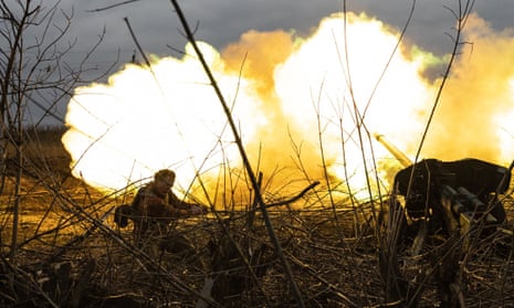A Ukrainian soldier reacts as he fires artillery towards Russian positions on the outskirts of Bakhmut, eastern Ukraine