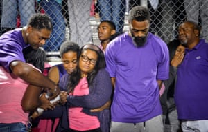 Shoshana Boyd and Olympic sprinter Tyson Gay stand surrounded by family and friends during a candlelight vigil at Lafayette high school for their daughter