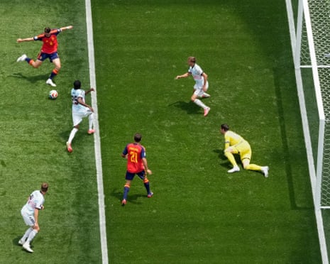 Spain's Fabian Ruiz scores their first goal past Belgium's keeper Thibaut Courtois.