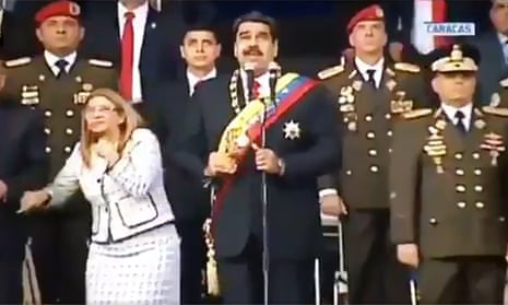 Venezuelan president Nicolas Maduro and his wife Cilia Flores react to the explosion during a ceremony in Caracas, which he has claimed was an assassination attempt.