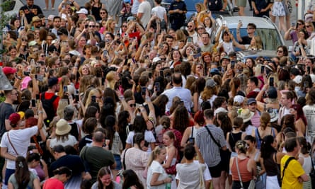 Crowd of young fans singing with raised arms in central Vienna