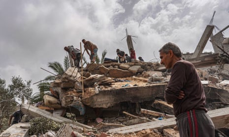 Palestinians check the rubble of a residential building destroyed in an Israeli strike in Al-Zawayda in the central Gaza Strip on May 11, 2024.
