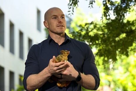 Independent senator David Pocock holds a baby possum as he speaks during a press conference addressing the Samuel review at Parliament House in Canberra, Thursday, 8 December 2022.