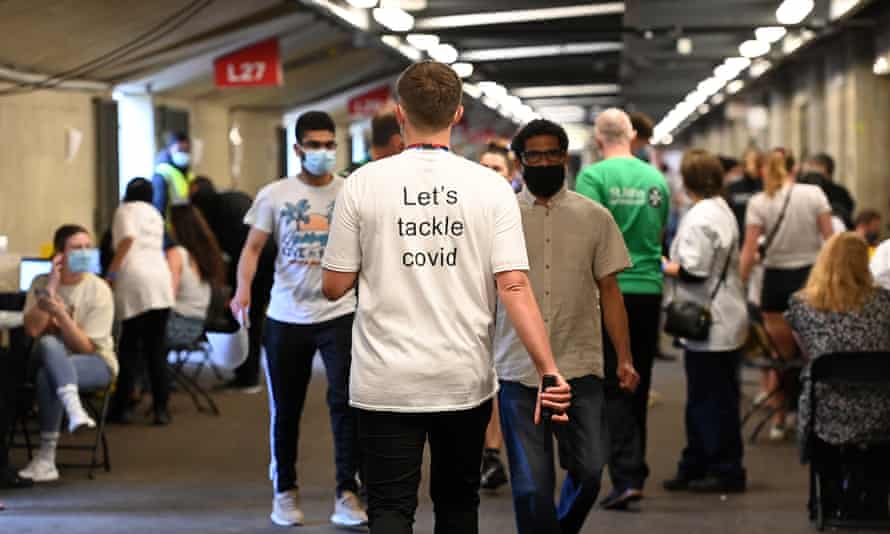 Young people wait to receive a Covid-19 vaccination jab at Twickenham rugby stadium in London