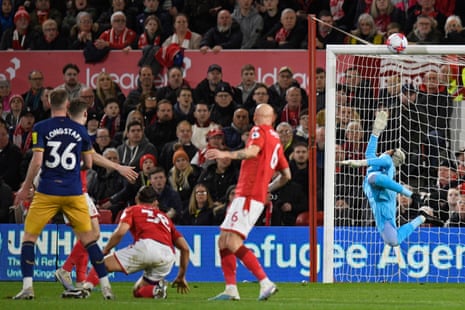 Newcastle United's English midfielder Sean Longstaff (left) watches as his shot hits the woodwork.