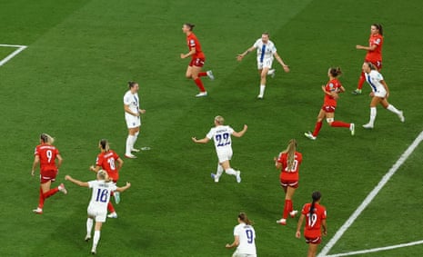 Finland's Natalia Kuikka celebrates scoring their first goal amidst her joyous teammates.