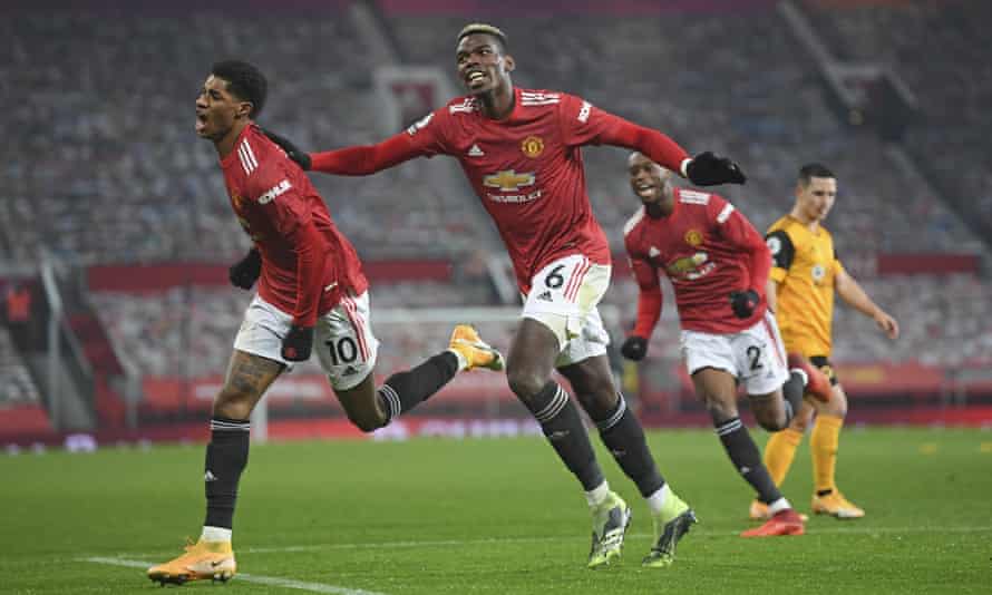 Rashford celebrates with Paul Pogba after scoring the winning goal late in the match against Wolves at Old Trafford on Tuesday.