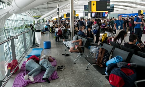 People sleep on a blanket at Heathrow Airport Terminal 5 after british airways meltdown