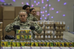 'A perfect storm': US facing hunger crisis as demand for food banks soars - The Guardian 8 Ohio National Gaurd Sgt. Kelley Kremer assists in repackaging emergency food boxes for food distribution at the Cleveland Food Bank, Tuesday, March 24, 2020, in Cleveland. State parks have shuttered cabins, golf courses and marinas as Ohio enters its first full day of a statewide “stay at home” order to slow the spread of the coronavirus. Grocery stores, gas stations and other essential businesses remain open.