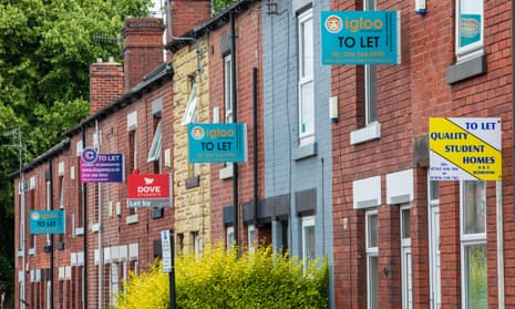 Row of terraced houses with 'to let' signs for student properties