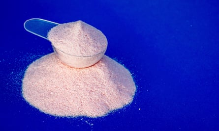 a scoop with strawberry flavoured creatine supplement