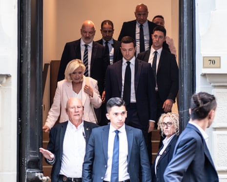 Marine Le Pen and Jordan Bardella leave the headquarters of the National Rally in Paris following the judgment of the Paris Court of Appeal.