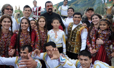 Steven Seagal and people in traditional dress in a specially built village, Kyrchin, at the games.