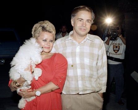 Jim and Tammy Faye Bakker with dog and reporters with flash
