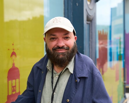Nasar Ahmed wearing peak cap against colourful backdrop