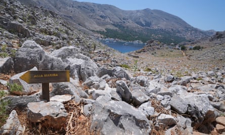 A direction sign on a rocky path in the hills above the fishing village of Pedi in Symi