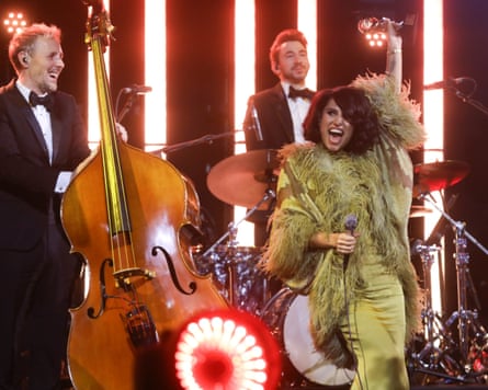Raye with her award, and her live band at the Mercury prize ceremony.