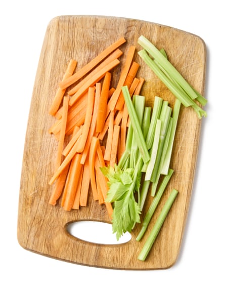 Batons of carrot and celery on a chopping board
