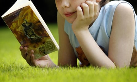 A child reading CS Lewis’s Prince Caspian. The writer John Boyne says: ‘I’ve grown less concerned with  how young people read and more fanatical about just getting them to read at all.’